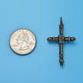 Cross size next to a Quarter