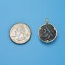 Pendant size next to a Quarter