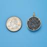 Pendant size next to a Quarter