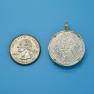 Pendant size next to a Quarter