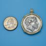 Pendant size next to a quarter