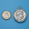 Pendant size next to a quarter