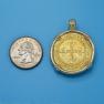 Pendant size next to a Quarter