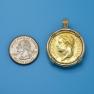 Pendant size next to a Quarter