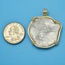 Pendant size next to a Quarter