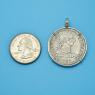Pendant size next to a Quarter