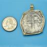 Pendant size next to a Quarter