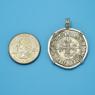 Pendant size next to a Quarter