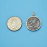 Pendant size next to a Quarter