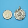 Pendant size next to a Quarter