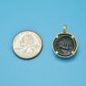 Pendant size next to a Quarter