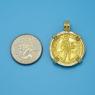 Pendant size next to a Quarter
