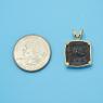 Pendant size next to a Quarter