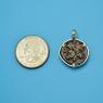 Pendant size next to a Quarter