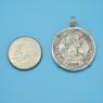 Pendant size next to a Quarter