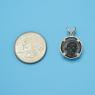 Pendant size next to a Quarter