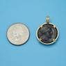 Pendant size next to a Quarter