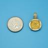 Pendant size next to a Quarter