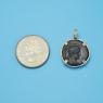 Pendant size next to a Quarter