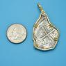 Pendant size next to a Quarter