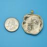 Pendant size next to a Quarter