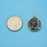 Pendant size next to a Quarter