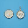 Pendant size next to a Quarter