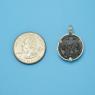 Pendant size next to a Quarter