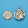 Pendant size next to a Quarter