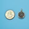 Pendant size next to a Quarter