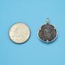 Pendant size next to a Quarter