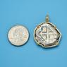Pendant size next to a Quarter