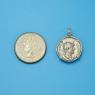 Pendant size next to a Quarter