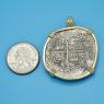 Pendant size next to a Quarter