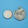 Pendant size next to a Quarter