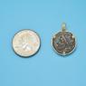 Pendant size next to a Quarter