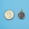 Pendant size next to a Quarter
