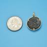 Pendant size next to a Quarter