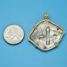 Pendant size next to a Quarter