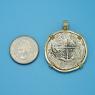 Pendant size next to a Quarter