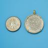 Pendant size next to a Quarter