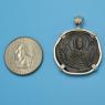 Pendant size next to a Quarter
