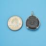 Pendant size next to a Quarter