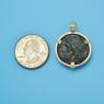Pendant size next to a Quarter