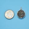 Pendant size next to a Quarter