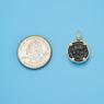 Pendant size next to a Quarter