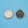 Pendant size next to a Quarter