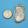 Pendant size next to a Quarter