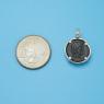 Pendant size next to a Quarter
