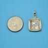Pendant size next to a Quarter